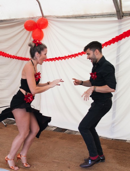 Salsa dancers Leanne and Alex warming up to live latin band Jan y su Salsa at a birthday party in Wiltshire